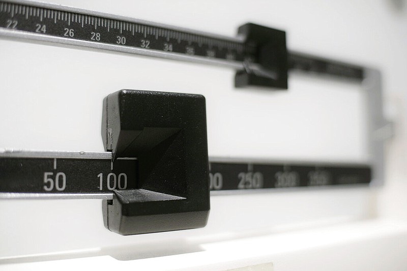 AP Photo by Patrick Sison / This 2018 file photo shows a closeup of a beam scale in New York. Last week, the American Academy of Pediatrics released new guidelines calling for more proactive treatment of childhood obesity.