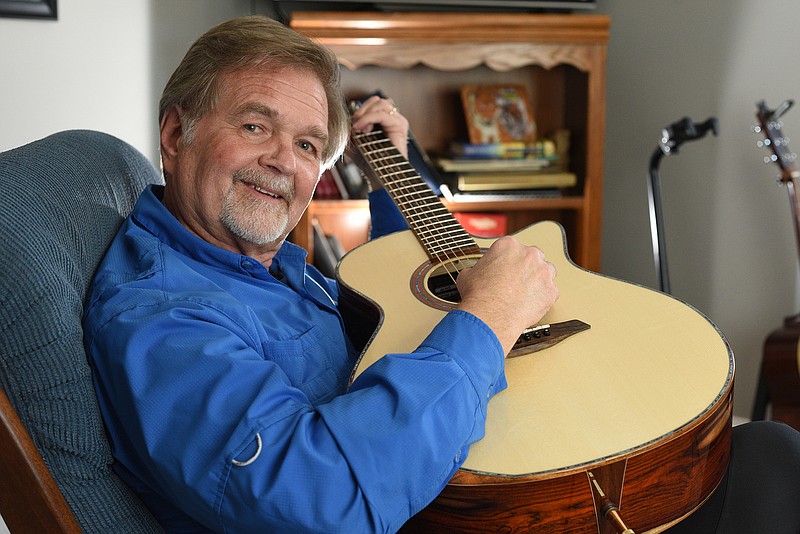 Staff photo by Matt Hamilton / Jim Moore, former frontman for The Animal Band, strums a guitar at his home in Ringgold, Ga.