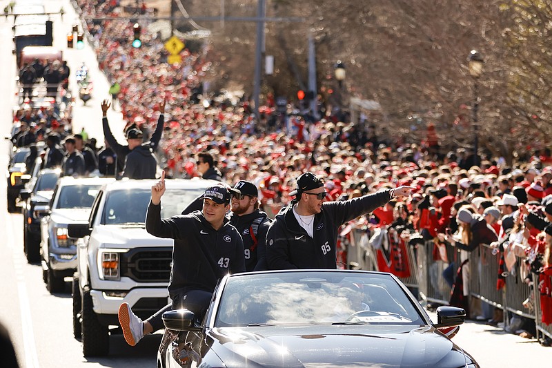 Georgia football players acknowledge the crowd during a parade celebrating the Bulldog's second consecutive NCAA college football national championship, Saturday, Jan. 14, 2023, in Athens, Ga. (AP Photo/Alex Slitz)