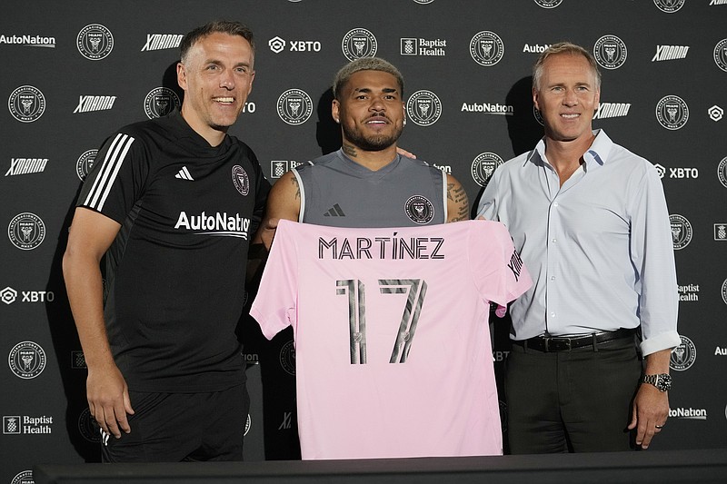 AP photo by Lynne Sladky / Veteran MLS striker Josef Martinez, center, holds an Inter Miami CF jersey as he poses with coach Phil Neville, left, and chief sporting director Chris Henderson during a news conference Wednesday in Fort Lauderdale, Fla.