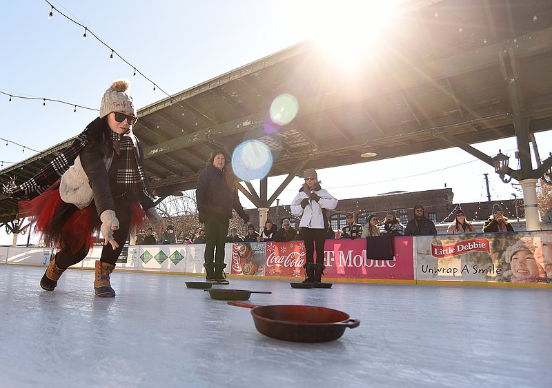 Staff Photo by Matt Hamilton / Chattanooga resident Laura Maley tosses a skillet for her team, the Twirly Curls, on Jan. 29 during the Skillet Curling Championship at Ice on the Landing at the Chattanooga Choo Choo.