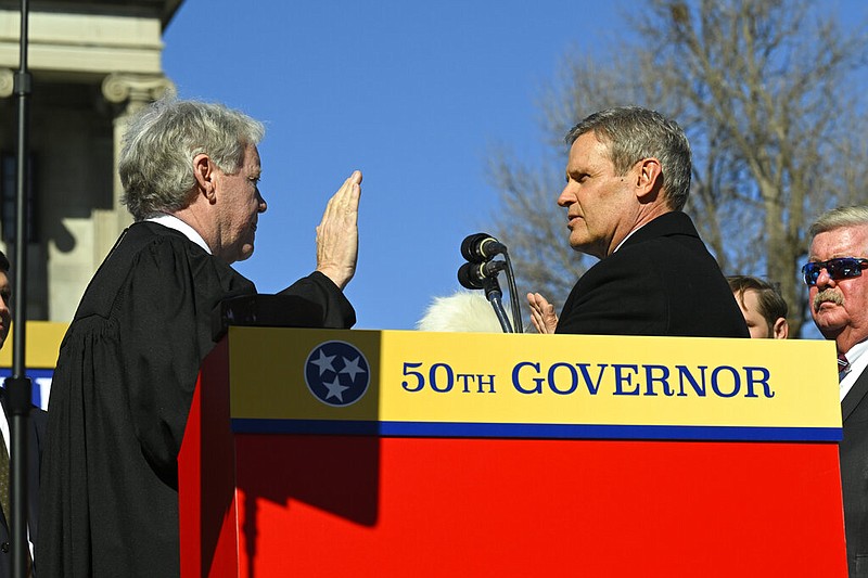 Tennessee Gov. Bill Lee, right, is sworn in by Tennessee Supreme Court Chief Justice Roger Page, left, in the Legislative Plaza Saturday, Jan.21, 2023, in Nashville, Tenn. (AP Photo/John Amis)