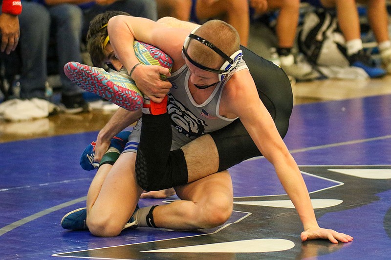 Staff photo by Olivia Ross / Trion's Crawford Lee, front, wrestles East Laurens' Tex Edge during a GHSA Class A state duals semifinal Saturday in Trion, Ga. Trion beat East Laurens 78-6 but then lost 33-32 to Mount Pisgah Christian in the championship match.