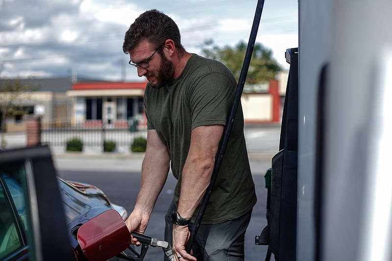 Staff photo by Troy Stolt / Ben Michaels pumps gas into his car at the Speedway gas station on the corner of S. Holtzclaw Ave. and E. 3rd Street on Oct. 11, 2021, in Chattanooga. The price of regular unleaded gasoline jumped by more than 26 cents a gallon last week in the biggest weekly increase since last spring.