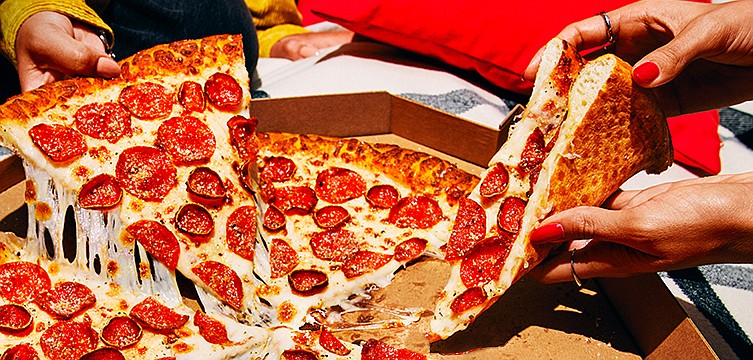 Pizza lovers can party like it's 1999 once the 1999-era Big New Yorker from Pizza Hut becomes available again, just in time for Super Bowl 2023. / Courtesy of Pizza Hut/TNS