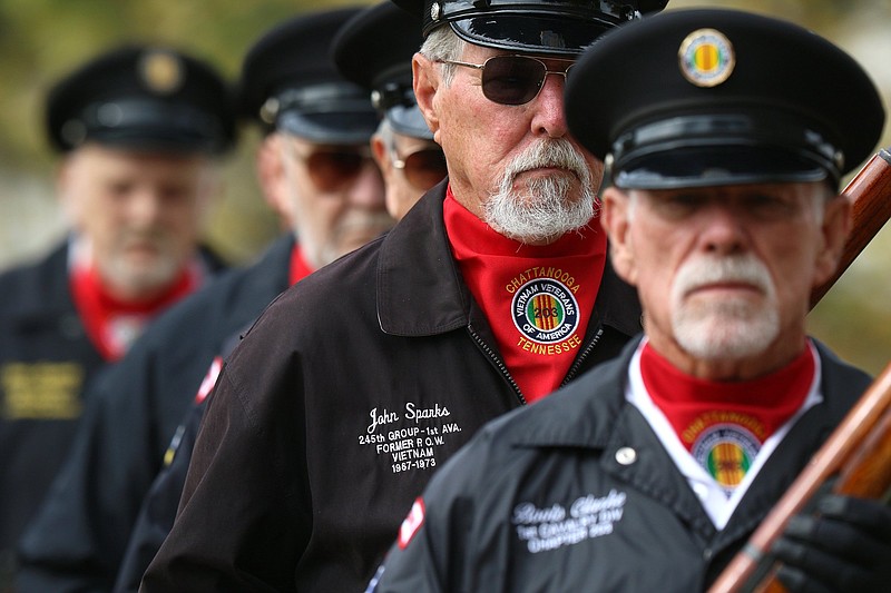 Staff File Photo / Former Vietnam prisoner of war John Sparks, second from right, stands with other honor guard members after a 21-gun salute during the Veterans Day program at the Chattanooga National Cemetery on Nov. 11, 2019.