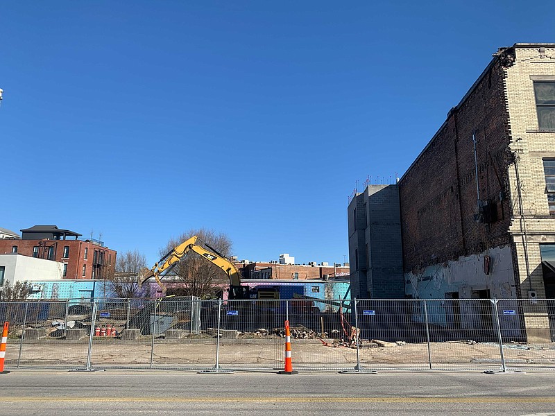 Staff Photo by Ellen Gerst / A building at 27 W. Main St. is demolished on Tuesday. Part of a brick wall collapsed two weeks earlier, crushing a car parked on the street.