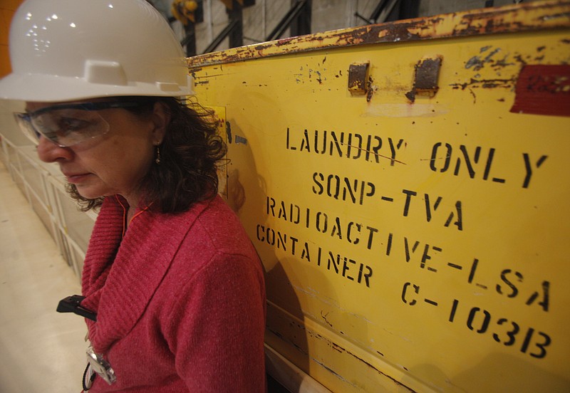 Staff file photo / Then-Chattanooga Times Free Press reporter Pam Sohn leans against a container on the refueling floor of the Sequoyah Nuclear Plant in January 2012 during a TVA tour in which the refueling process was explained.