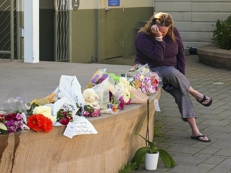 Photo/Jim Wilson/The New York Times / On Wednesday, Jan. 25, 2023, Elisabeth Olander wipes tears from her eyes at a makeshift memorial for the seven victims of a mass shooting that occurred two days earlier in Half Moon Bay, Calif.