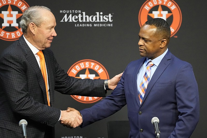 AP photo by David J. Phillip / Houston Astros owner Jim Crane, left, shakes hands with Dana Brown during a news conference after his hire as the team's general manager was announced Thursday. Brown was the vice president of scouting for the Atlanta Braves the past four seasons.