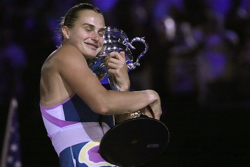 AP photo by Dita Alangkara / Aryna Sabalenka hugs her championship trophy after defeating Elena Rybakina 4-6, 6-3, 6-4 to win the Australian Open on Saturday in Melbourne. It's the first Grand Slam championship for Rybakina, a 24-year-old from Belarus.