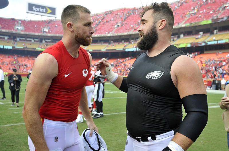 FILE - Kansas City Chiefs tight end Travis Kelce, left, talks to his brother, Philadelphia Eagles center Jason Kelce, after they exchanged jerseys following an NFL football game in Kansas City, Mo., Sept. 17, 2017. For the first time in Super Bowl history, a pair of siblings will play each other on the NFL's grandest stage. Travis helped the Chiefs return to their third championship game in four seasons on Sunday night when they beat the Bengals for the AFC title, while Jason has the Eagles back for the second time in six years after their NFC title win over the 49ers. (AP Photo/Ed Zurga, file)