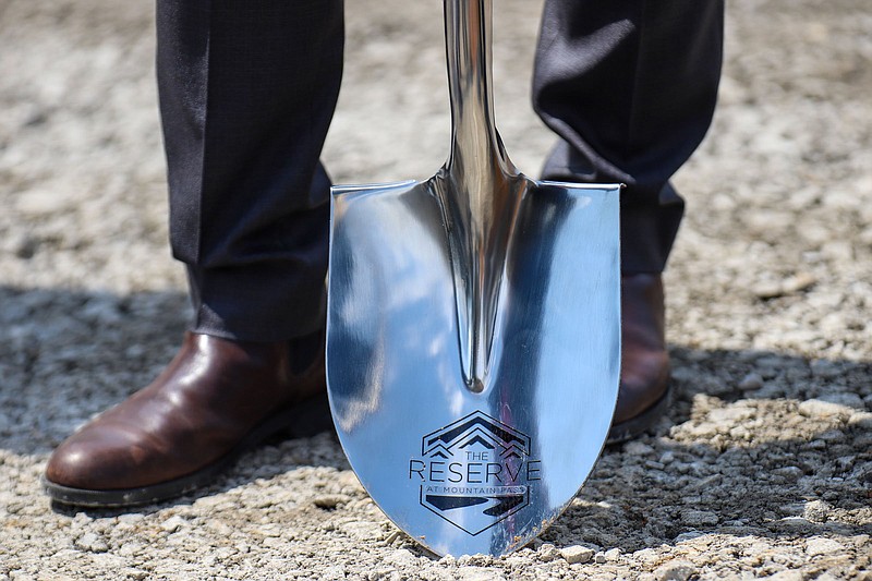 Staff photo by Olivia Ross  / Mayor Tim Kelly holds one of the shovels used at the groundbreaking of The Reserve at Mountain Pass on April 12, 2022. This affordable housing complex will be located in the Alton Park area.