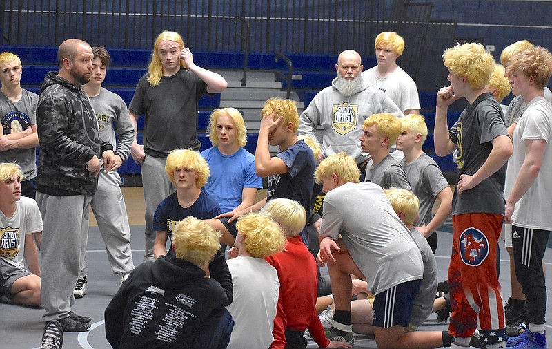Staff photo by Patrick MacCoon / Soddy-Daisy wrestling coach Ulric Winesburgh, left, talks to the Trojans at practice Thursday ahead of Saturday's TSSAA Class A state duals in Franklin.