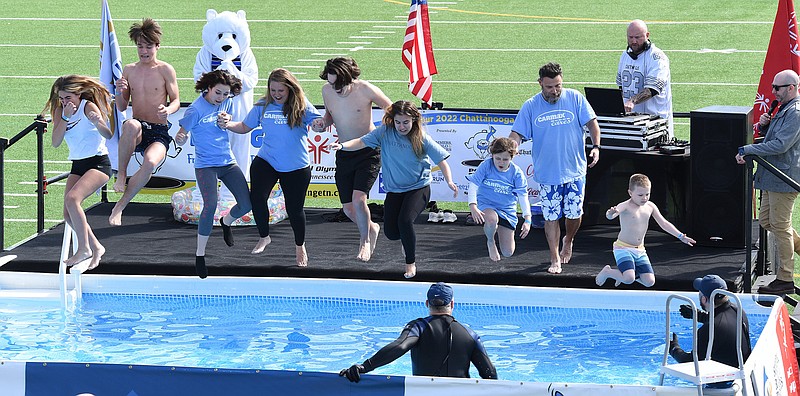 Staff Photo by Matt Hamilton / A group representing CarMax jumps into the chilly waters Feb. 12 during the Chattanooga Polar Plunge at Finley Stadium.
