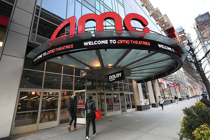 FILE - People walk by the AMC 34th Street theater on March 5, 2021, in New York. AMC Theaters, the nation's largest movie theater chain, on Monday unveiled a new pricing scheme in which seat location determines how much your movie ticket costs. Seats in the middle will cost a dollar or two more, while seats in the front row will be slightly cheaper. (Photo by Evan Agostini/Invision/AP, File)