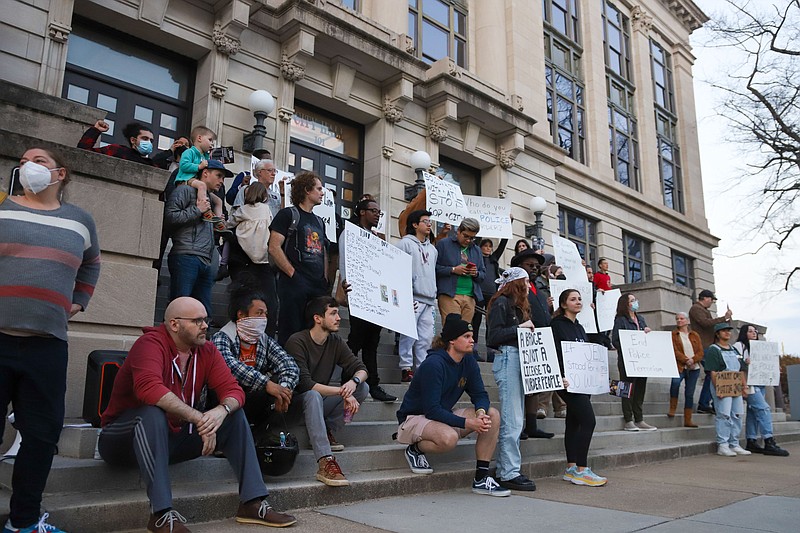 Staff Photo by Olivia Ross / Individuals with Concerned Citizens for Justice gather on the steps leading to City Hall earlier this week in a protest organized to end police terrorism.