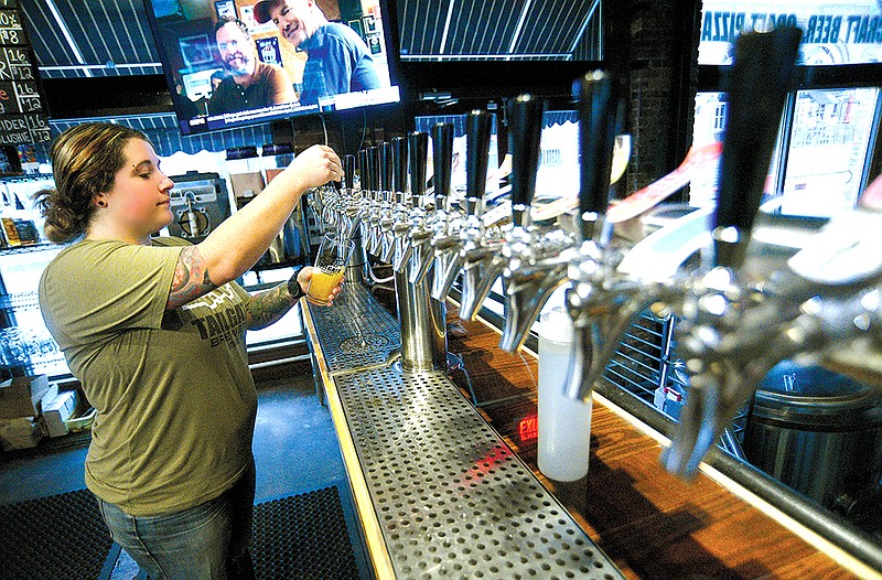 Staff photo by Matt Hamilton / Beertender Shannon Joyce pours a beer at Chattanooga’s TailGate Brewery, one of the many stops along the Tennessee Ale Trail.