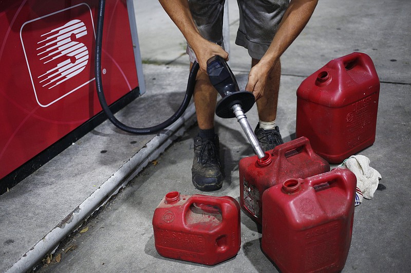 Photo/Luke Sharrett/The New York Times / A man fills up gasoline cans at a gas station in Conway, S.C., on Sept. 11, 2018. In 2020, a new law (the "Portable Fuel Container Safety Act of 2020") went into effect that requires portable gas containers, such as plastic gas cans, have special devices installed to prevent explosions from igniting inside them.