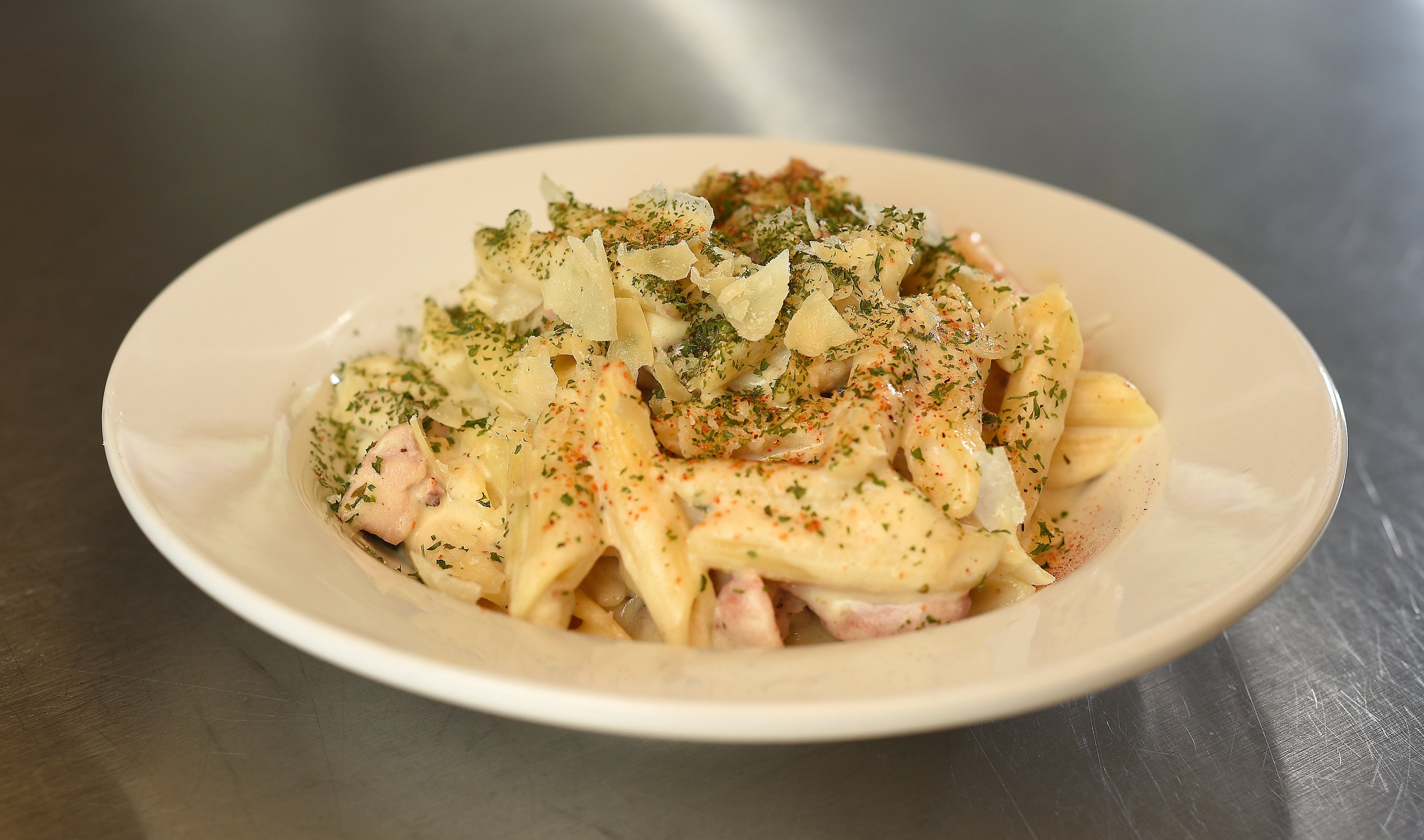 Staff Photo by Matt Hamilton / A plate of baked smoked chicken Alfredo prepared by chef Cornelius Lathan at the Kitchen Incubator of Chattanooga.