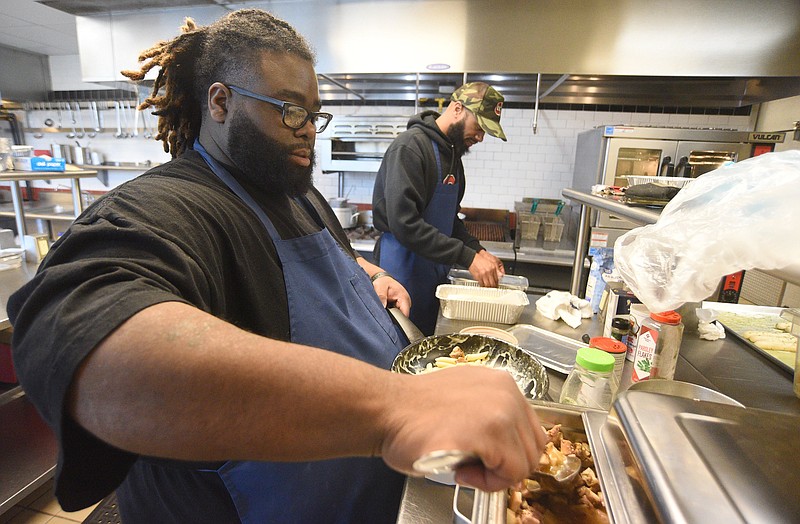 Staff Photo by Matt Hamilton / Chef Cornelius Lathan, front, works with Landas Richards at the Kitchen Incubator of Chattanooga.