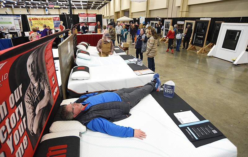 Staff File Photo by Matt Hamilton / Bill Wilson, of Chattanooga, tests out a mattress at the Murmaid Mattress booth during the 55th annual Tri-State Home Show in 2022 at the Chattanooga Convention Center. The event was sponsored by the Home Builders Association of Greater Chattanooga and EPB Fiber Optics.