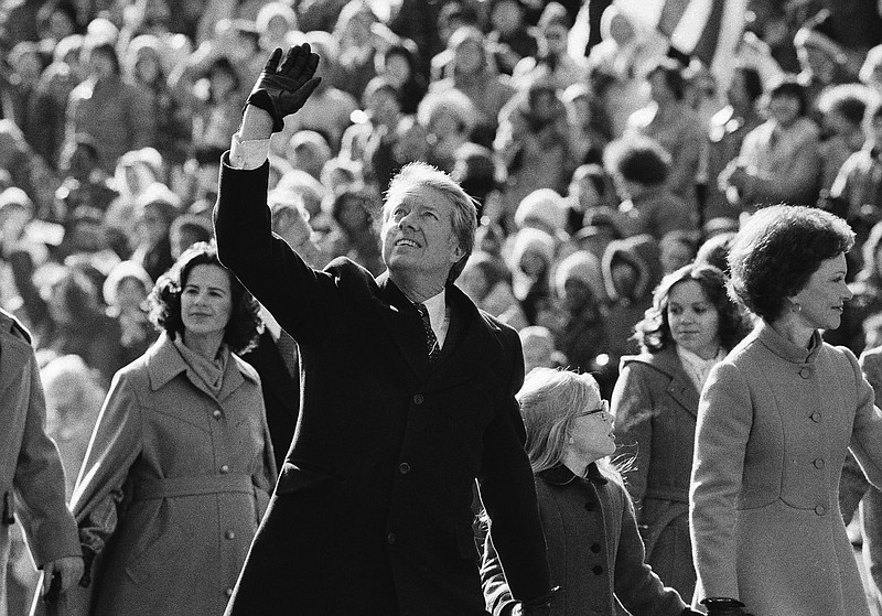 AP File Photo/Suzanne Vlamis / President Jimmy Carter waves to the crowd while walking with his wife, Rosalynn, and their daughter, Amy, along Washington, D.C.'s Pennsylvania Avenue following his inauguration on Jan. 20, 1977.