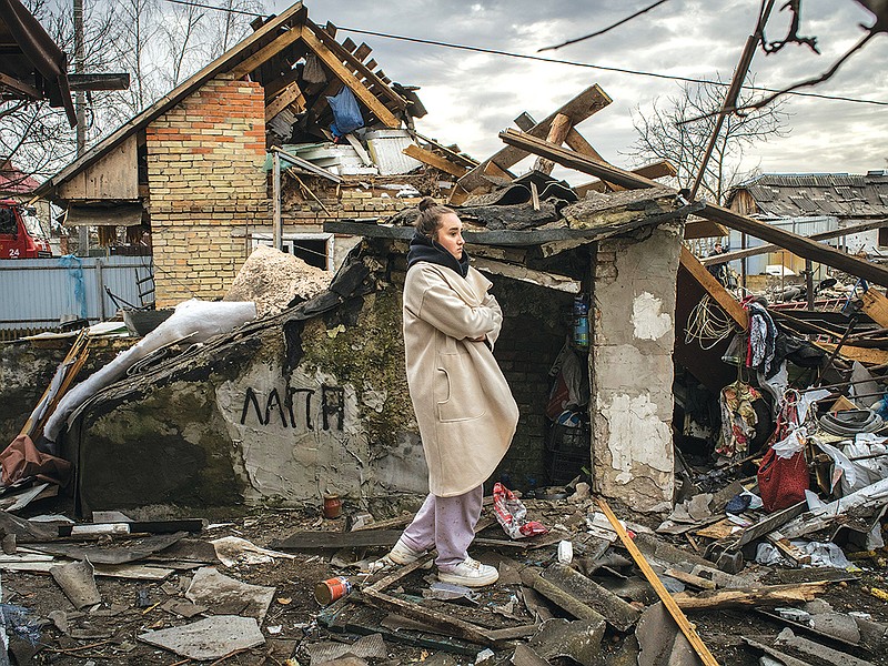 Valya Kravchun surveys the damage to her neighborhood in Kyiv, Ukraine after a Russian strike on Thursday, Dec. 29, 2022. Explosions rocked towns and cities around Ukraine on Thursday morning, and electricity went out in several regions as Russia launched what appeared to be one its biggest strikes to date on the country’s energy grid. (Laura Boushnak/The New York Times)