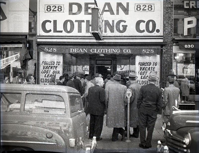 Chattanooga News-Free Press file photo via ChattanoogaHistory.com. Customers stand outside the Dean Clothing Co. on Market Street in 1951. The store was closing due to a lost lease but later reopened a couple of blocks away at 614 Market St.