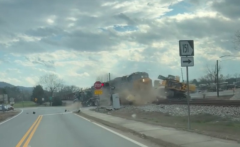 Contributed photo / After becoming stuck on a railroad crossing in Ringgold, a semi-truck and trailer carrying an excavator was struck by a CSX train Monday afternoon.