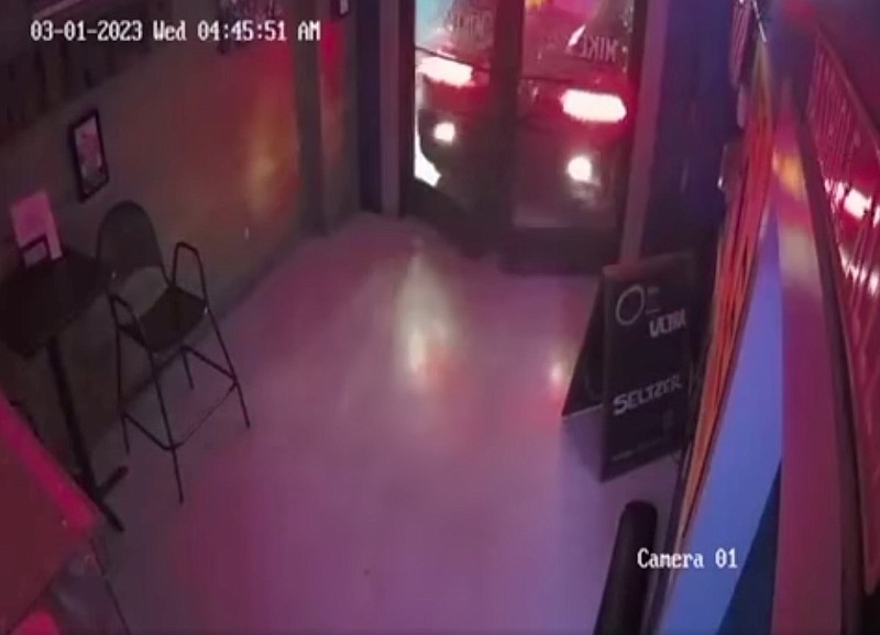 Contributed video image / In this screenshot of security footage from inside Mike's Hole in the Wall, a car can be seen backing into the doors early Wednesday.