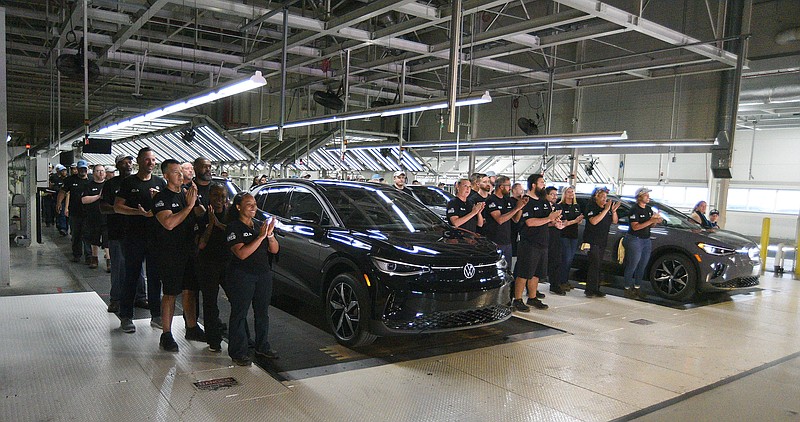 Staff file photo by Matt Hamilton / Workers applaud after walking in with new vehicles during the launch celebration for the Volkswagen ID.4 electric SUV at the Chattanooga Volkswagen assembly plant on Oct. 14, 2022.