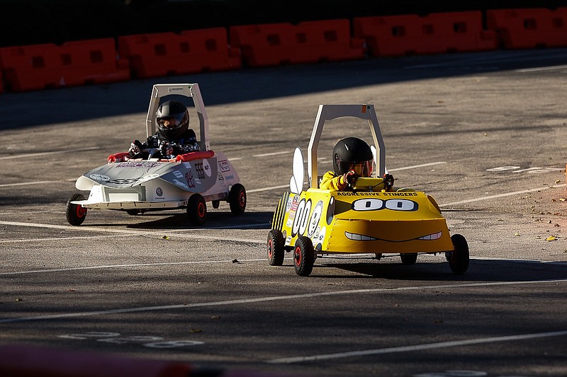 Staff file photo / The Lookout Valley Elementary Aggressive Stinger Yellow Team car and the Harrison Elementary Team car speed through the track during the fall Chattanooga Fall Green Prix on Nov. 19, 2021.