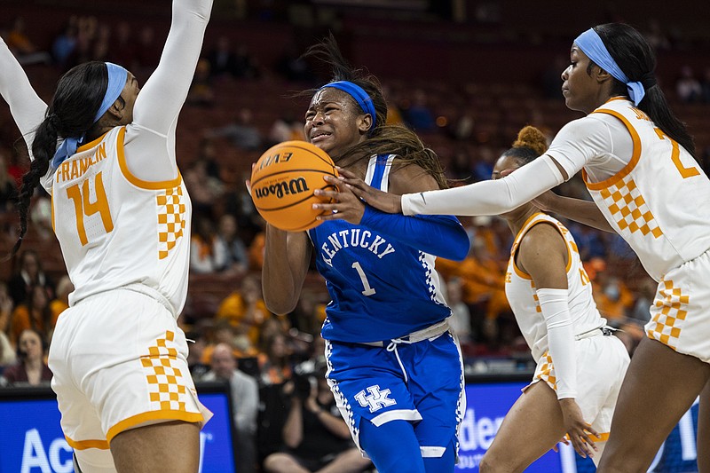 AP photo by Mic Smith / Kentucky's Robyn Benton drives between Tennessee's Jasmine Franklin (14) and Rickea Jackson during an SEC tournament quarterfinal Friday night in Greenville, S.C.