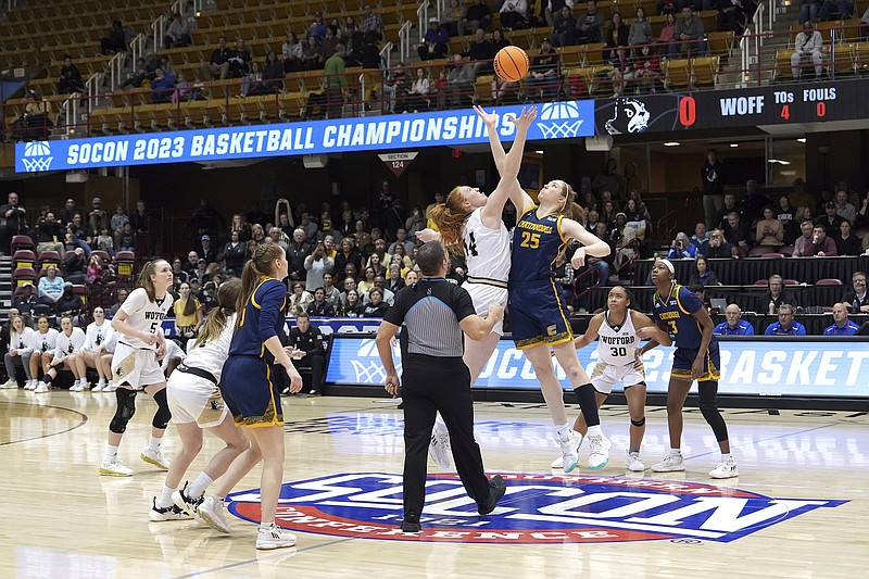 AP photo by Kathy Kmonicek / UTC's Abbey Cornelius (25) and Wofford's Lilly Hatton battle for the opening tipoff at Sunday's SoCon women's tournament title game in Asheville, N.C.