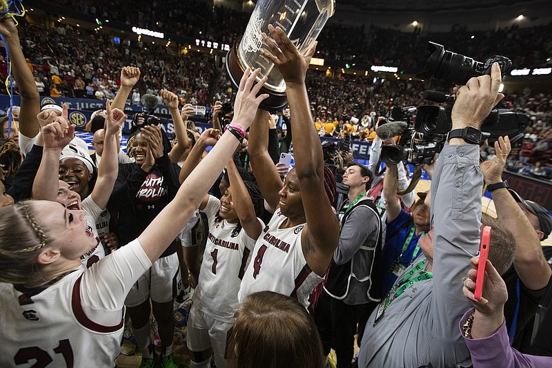 AP photo by Mic Smith / South Carolina's Aliyah Boston holds up the SEC women's basketball tournament championship trophy after the top-ranked Gamecocks defeated Tennessee 74-58 on Sunday in Greenville, S.C.