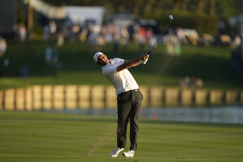 AP photo by Chaerlie Neibergall / Scottie Scheffler hits from the 18th fairway on the Players Stadium Course at TPC Sawgrass during the third round of The Players Championship on Saturday in Ponte Vedra Beach, Fla.