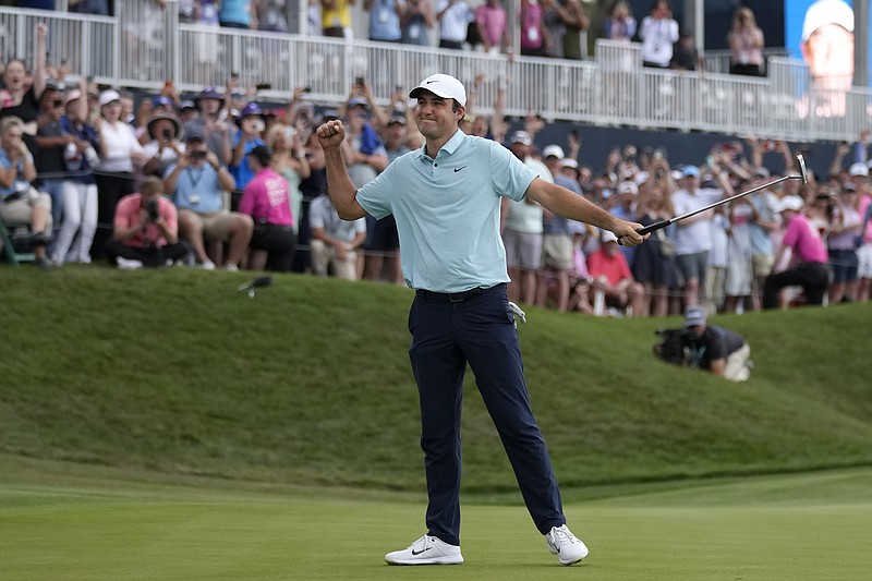 AP photo by Charlie Neibergall / Scottie Scheffler celebrates after winning The Players Championship by five strokes Sunday in Ponte Vedra Beach, Fla.