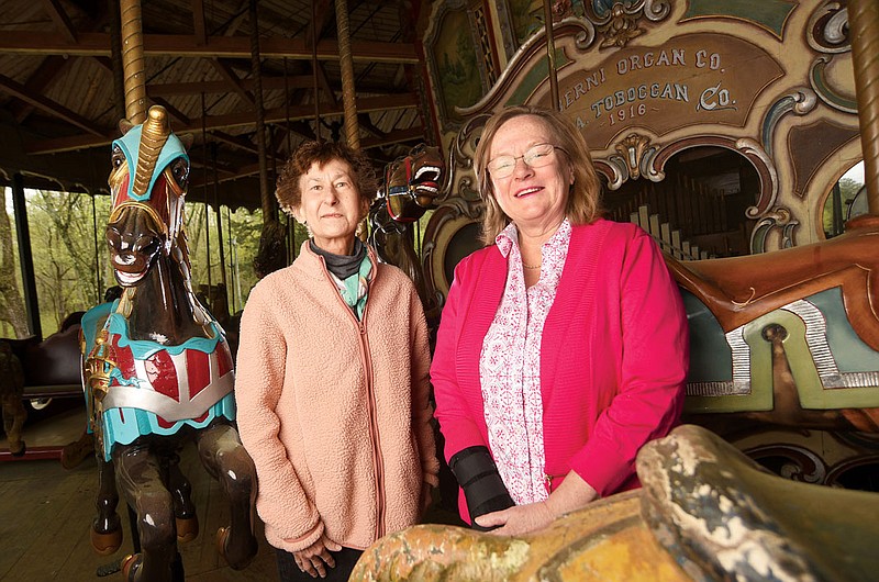 Photography by Matt Hamilton / Lake Winnepesaukah owners Talley Green, left, and Tennyson Dickinson on a carousel at the amusement park.