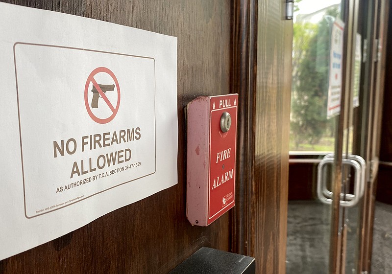 Staff Photo by Robin Rudd / A sign on the door of Tailgate Brewery, on Market Street, prohibits weapons inside the business. The photograph was made on Monday.