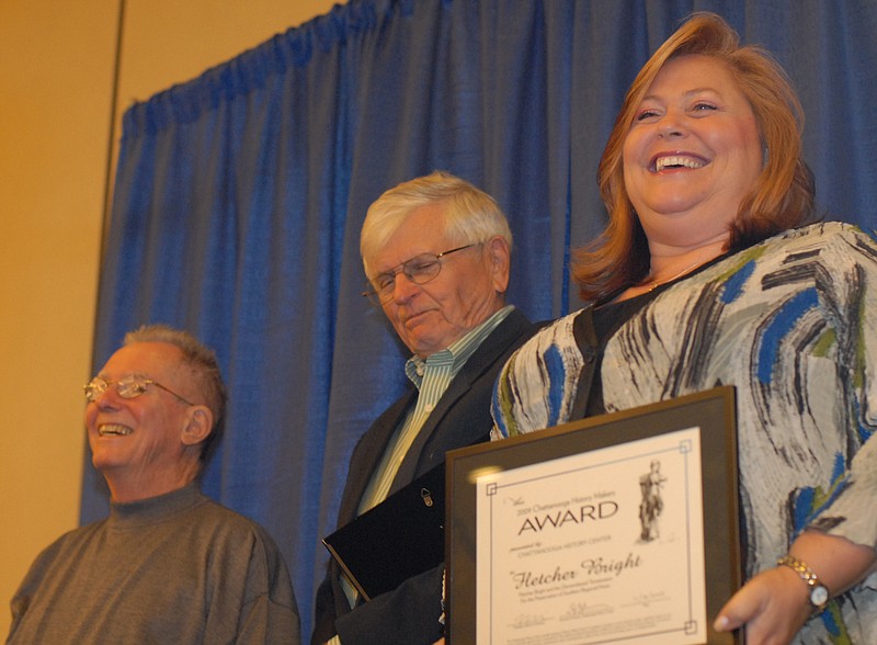 Staff file photo / Laura Walker, right, the bass player of the Dismembered Tennesseans, stands next to bandmates Ansley Moses, center, and Doc Cullis after they accepted plaques at the Chattanooga History Center's Chattanooga History Makers awards in 2014 at the Convention Center. The band was recognized for their dedication to and dissemination of bluegrass music in the area.