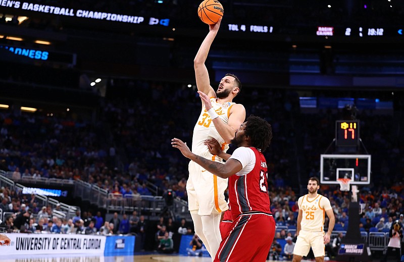 Tennessee Athletics photo / Tennessee senior forward Uros Plavsic shoots over Louisiana junior forward Jordan Brown during the early stages of Thursday night's 58-55 win by the Volunteers,