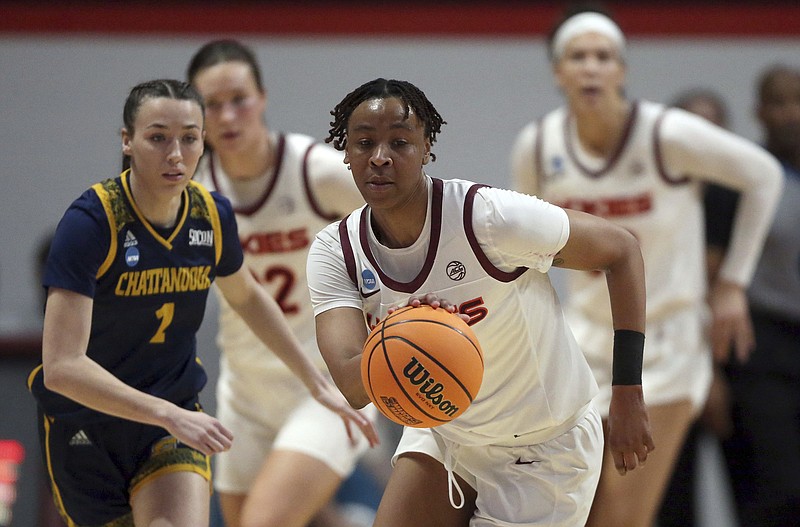 AP photo by Matt Gentry / Virginia Tech's D'Asia Gregg dribbles away from UTC's Audrey Canter (1) during the fourth quarter of an NCAA tournament first-round game Friday in Blacksburg, Va.