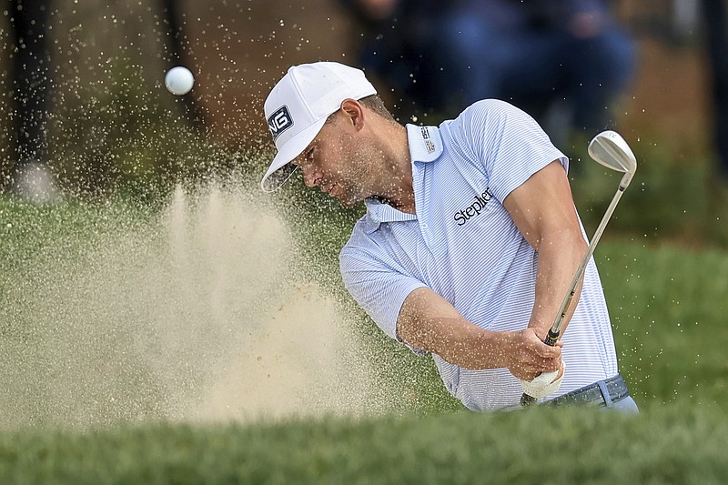 AP photo by Mike Carlson / Taylor Moore hits out of the bunker on the 17th hole on the Copperhead Course at Innisborook Resort during the final round of the PGA Tour's Valspar Championship on Sunday in Palm Harbor, Fla.