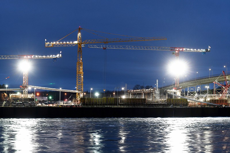 Staff Photo by Robin Rudd / Work continues on the Chickamauga Dam lock replacement, before dawn, on Feb. 1.  Shimmick Construction Co. is building a new lock chamber beneath the dam, and the contractor wants more time and money to complete its work.