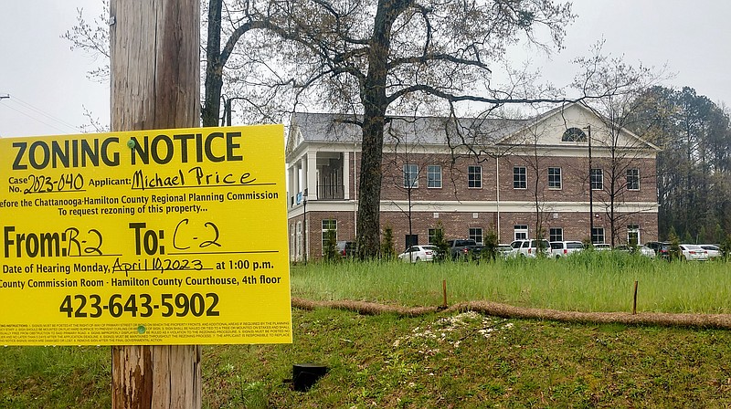 Staff photo by Mike Pare / A rezoning sign is posted in front of a tract at Apison Pike and Old Lee Highway on Wednesday. A developer is looking at building new office space similar to that pictured in the background.