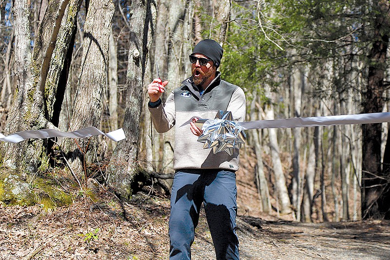 Staff photo by Olivia Ross / Patrick Kelly cuts the ribbon at the opening ceremony of Lula Lake's new Durham Mine Trails. The March 2023 event was kicked off with live music, food and more.