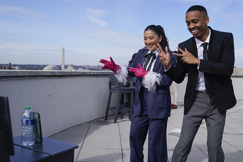 TikTok influencers Janette Ok and Imani Carrier record a video during a media availability, Wednesday, March 22, 2023, in Washington. (AP Photo/Jess Rapfogel)