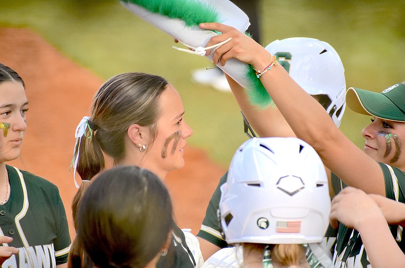 Staff photo by Patrick MacCoon / Silverdale Baptist junior Kennedy Stinson, with her batting helmet off, is greeted at the plate by her teammates after hitting a home run in Thursday's 7-5 home win over Chattanooga Christian School.