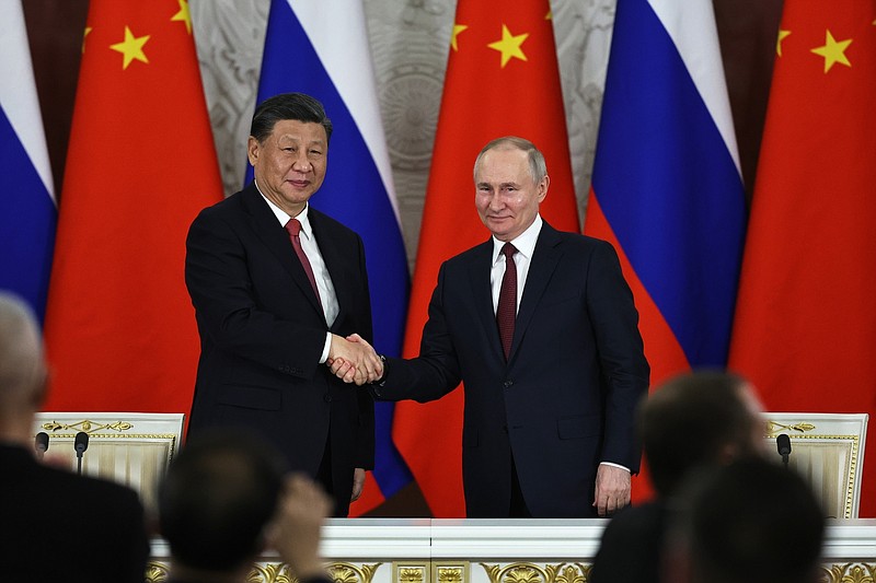 Photo/Mikhail Tereshchenko, Sputnik, Kremlin Pool Photo via AP/ Russian President Vladimir Putin, right, and Chinese President Xi Jinping shake hands after speaking to the media during a signing ceremony following their talks at The Grand Kremlin Palace, in Moscow, Russia, March 21, 2023.